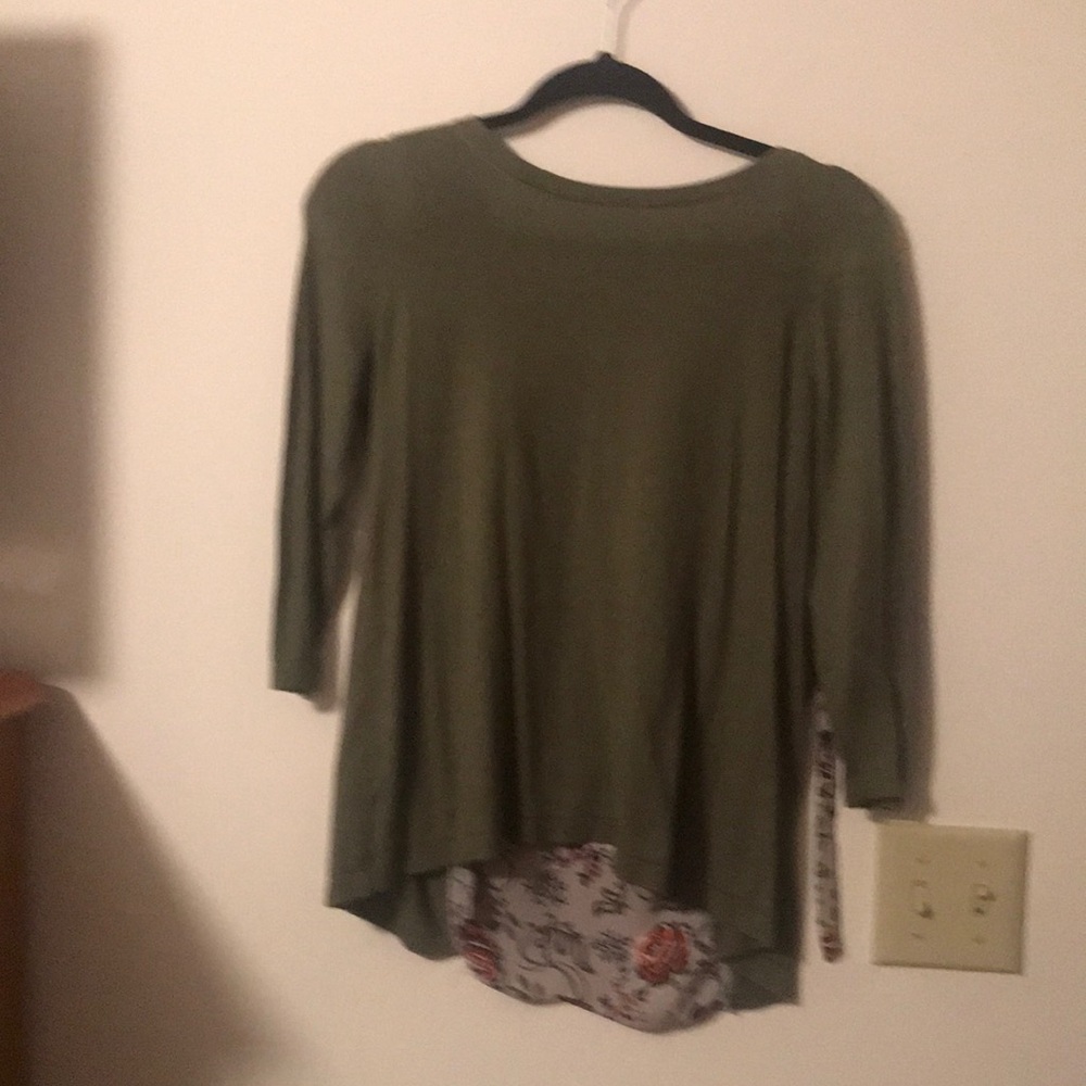 Green sweater three-quarter length sleeve has floral panel in the back